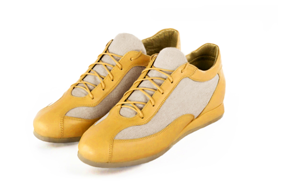 Mustard yellow and natural beige women's two-tone elegant sneakers. Round toe. Flat wedge soles. Front view - Florence KOOIJMAN